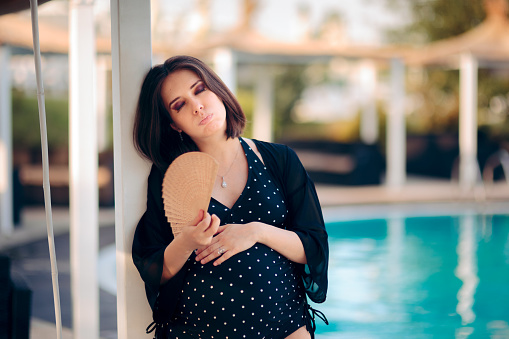 Mother to be having hot flashes and fanning herself