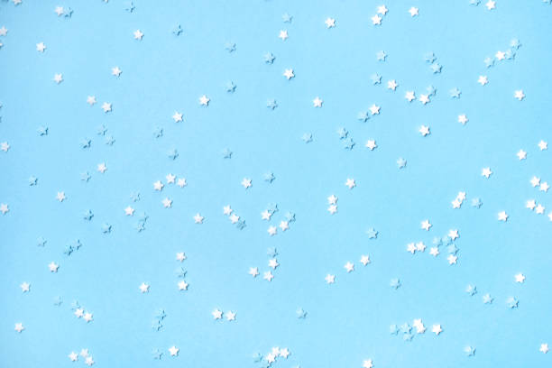 istock Little stars confetti on blue background 1163868581