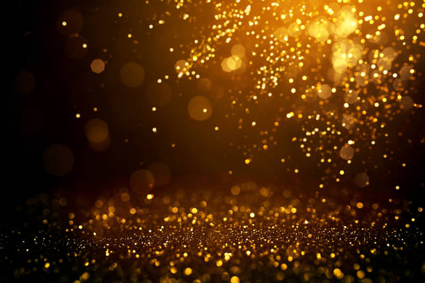 istock Golden abstract bokeh on black background. 1163869670