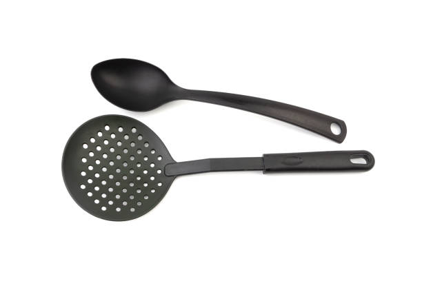 istock Black kitchen spatula and spoon utensils on white background 1163871606