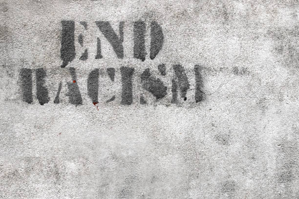 End racism Graffiti on brick wall say - END RACISM. Ideal for concepts and backgrounds. ending racism stock pictures, royalty-free photos & images