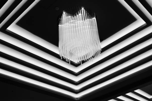 atmosphere of warm, inviting light, a hotel lobby; cascading ceiling chandelier; abstract image