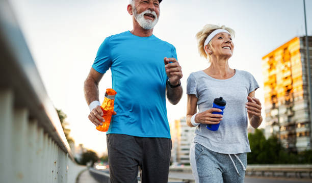 istock Mature couple jogging and running outdoors in nature 1163873854