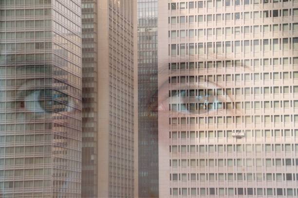 istock Multiple exposure portrait against skyscrapers 1163874848