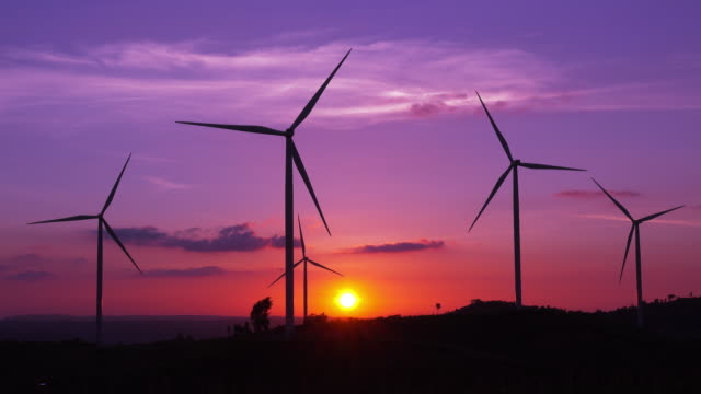 Silhouette Wind Turbines farm at sunset