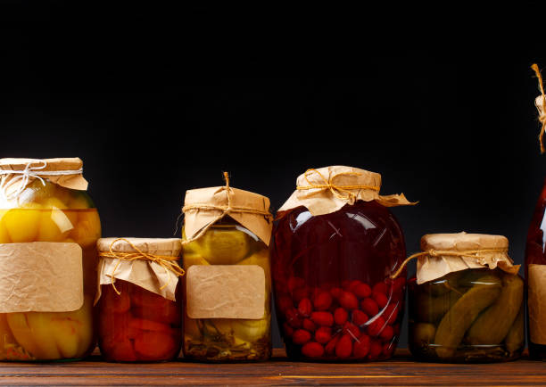 istock glass bottle with preserved food on black background - Image 1163879900