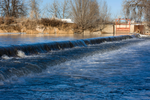 Lowhead dam diverting water for farmland irrigation - South Platte River in Colorado near Greeley