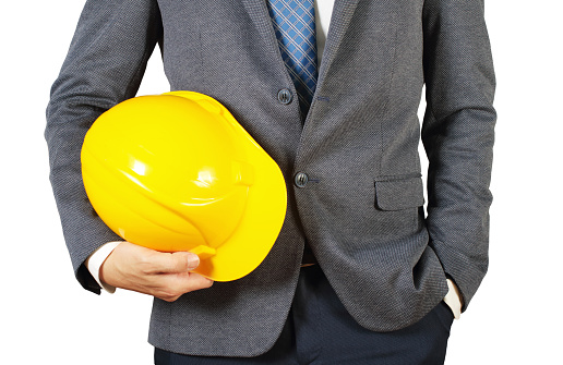 Engineer holding yellow helmet
