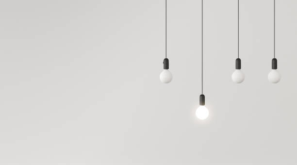 istock Mock up of hanging light bulbs with one glowing on white wall background,Conceptual idea,Outstanding. 3D rendering 1163886932