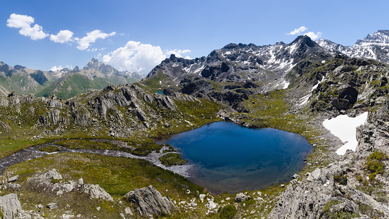 The Lac Bleu in Chianale, mountain lake in the italian alps of Cuneo, Piedmont, facing the famous Monviso peak (mount viso)