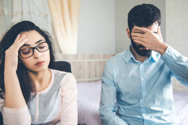 istock sad woman with man in home 1163887338