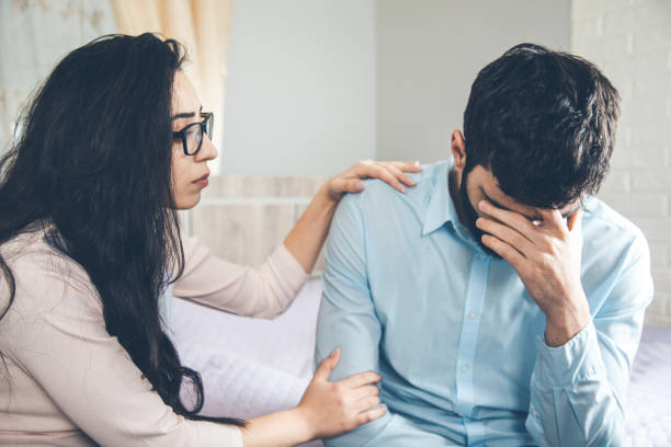 istock sad man with woman in home 1163887345