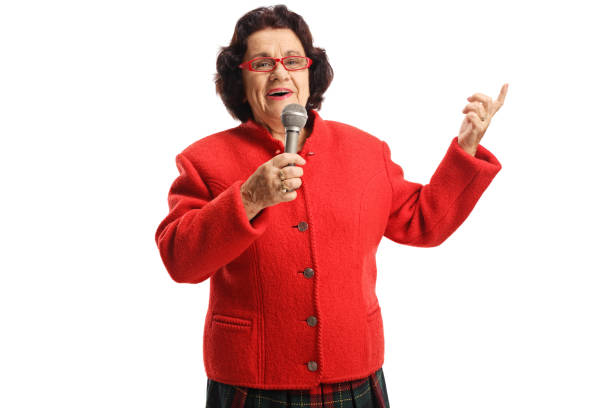 istock Senior woman holding a microphone and singing 1163888748