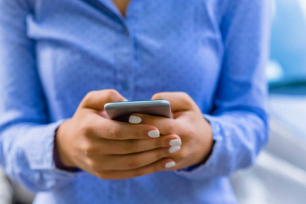 istock Woman Using a Smart Phone in the City Streets 1163889522