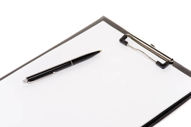 istock KYIV, UKRAINE - MAY 14, 2019: black pen and empty clipboard isolated on white 1163890047