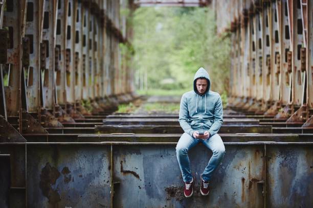 istock Lonely man with smartphone 1163890998