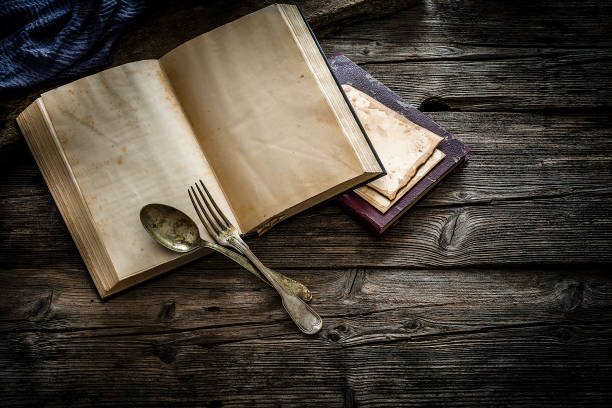 istock Vintage open cookbook on wooden table 1163892679