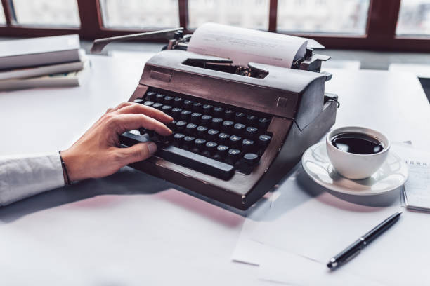 istock Male hand with a retro typewriter 1163893135