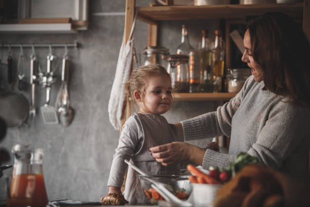 istock Mother adjusting apron she put on her toddler daughter 1163893265