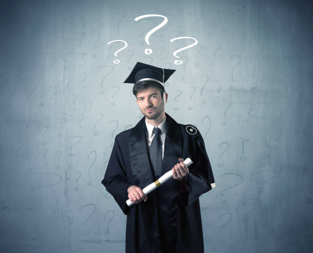 istock Young graduate teenager with question marks drawn 1163894514