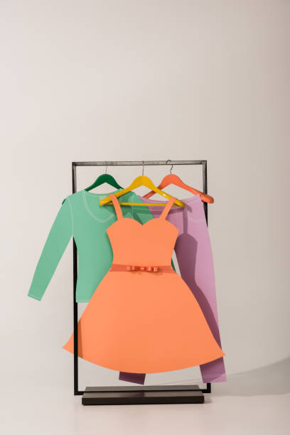istock rack with colorful paper clothes on white 1163894546