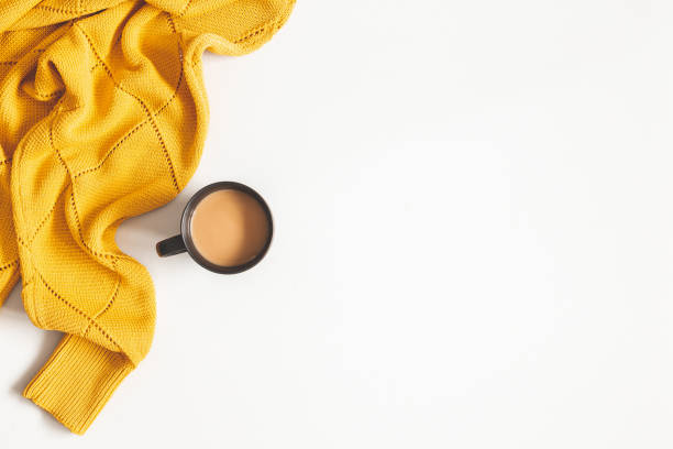 istock Autumn composition. Cup of coffee, yellow sweater on white background. Autumn, fall concept. Flat lay, top view, copy space 1163896268