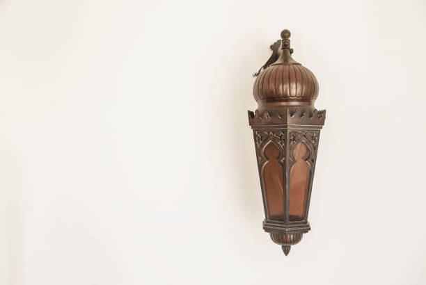 Oriental wooden lamp on white wall background.