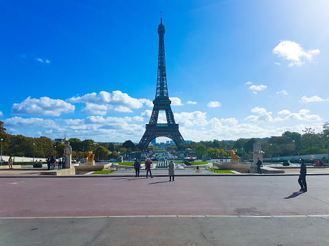 PARIS, FRANCE - OCTOBER 20, 2017: Blue skies and clouds on abeautiful morning overlooking the Eiffel Tower from the Jardins du Trocadero in Paris, France.