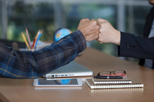 istock Business people join hand together during their meeting teamwork concepts 1163899605
