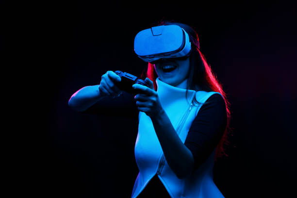 istock Woman with virtual reality headset is playing game. 1163900764