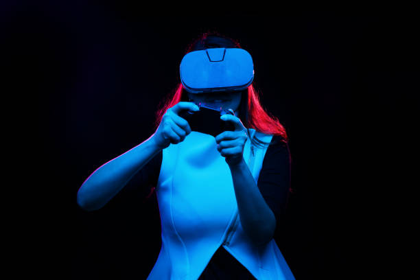 istock Woman with virtual reality headset is playing game. 1163900799