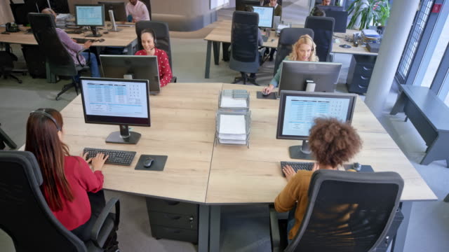 CS A team of female agents in the call centre working at their stations