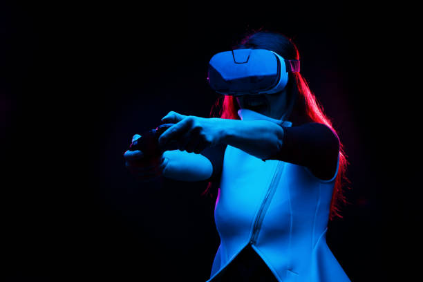 istock Woman with virtual reality headset is playing game. 1163900930