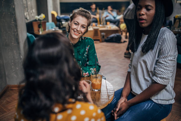 istock Young ladies sitting in cafe 1163900979