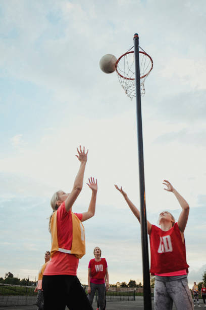istock Female Netball Team Scoring A Goal 1163901076