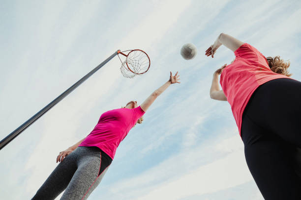 istock Two Women Play A Netball Game 1163901181