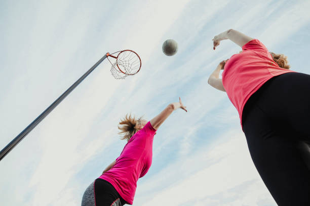 Two Women Play Netball