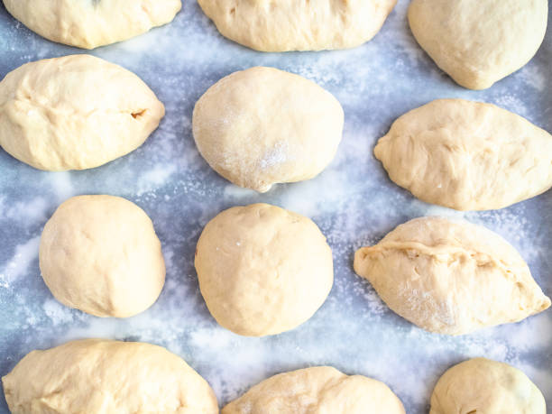 istock raw handmade sweet buns on baking paper 1163902501