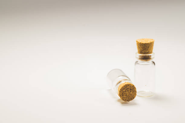 istock Empty little bottles with cork stopper isolated on white. glass vessels. transparent containers. test tubes. copy space 1163904844