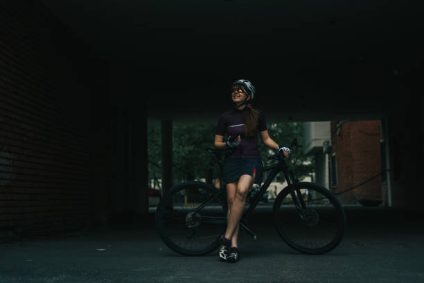 istock Woman posing next to her bicycle. 1163905049