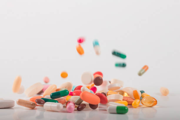 istock Pharmacy background on white background. Levitation pills. Tablets on white background which falling down. Pills. Medicine and healthy. Close up of capsules. Differend kind of pills 1163905365