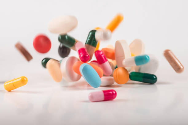 istock Pharmacy background on white background. Levitation pills. Tablets on white background which falling down. Pills. Medicine and healthy. Close up of capsules. Differend kind of pills 1163905434