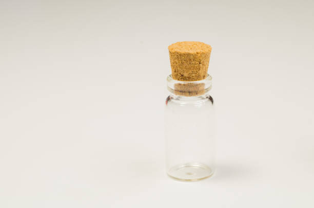 istock Empty little bottle with cork stopper isolated on white. glass vessel. transparent container. test tube. copy space 1163905513