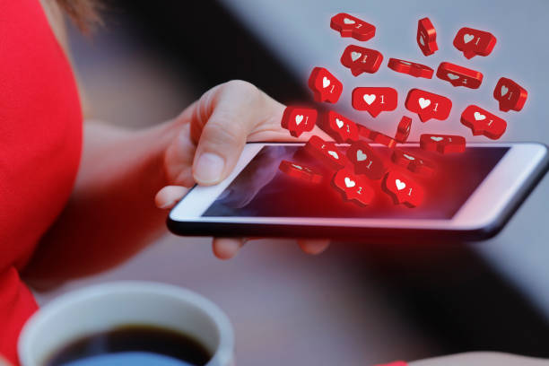 istock Women holding mobile phone with social media notification icon 1163906241