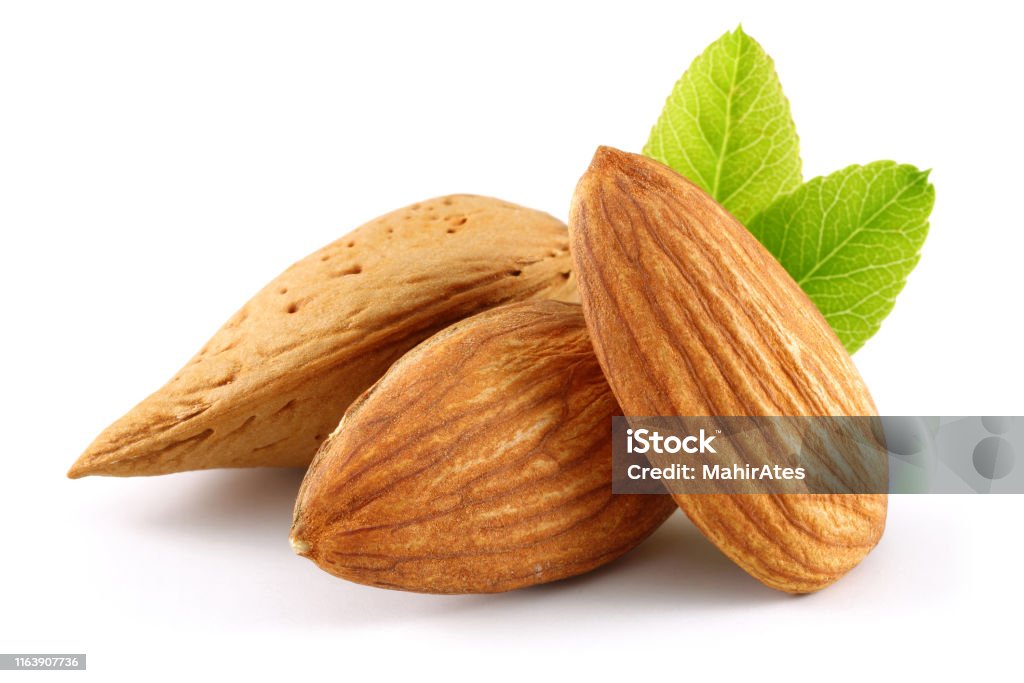 Almonds and green leaves isolated on white Almonds and green leaves isolated on white background Almond Stock Photo