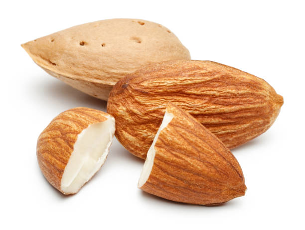 istock Group of almonds isolated on white 1163908681
