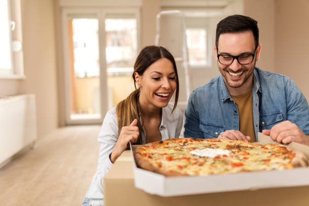 istock Happy couple eating pizza. 1163908755