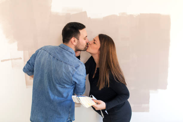 istock Husband and wife redecorating apartment. 1163908796