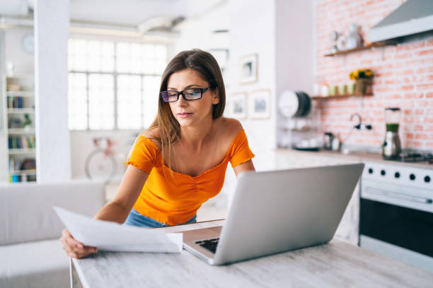 istock Woman working and using laptop at home 1163909279