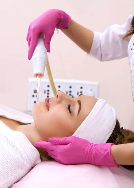 istock Receiving electric darsonval facial massage procedure. 1163910676